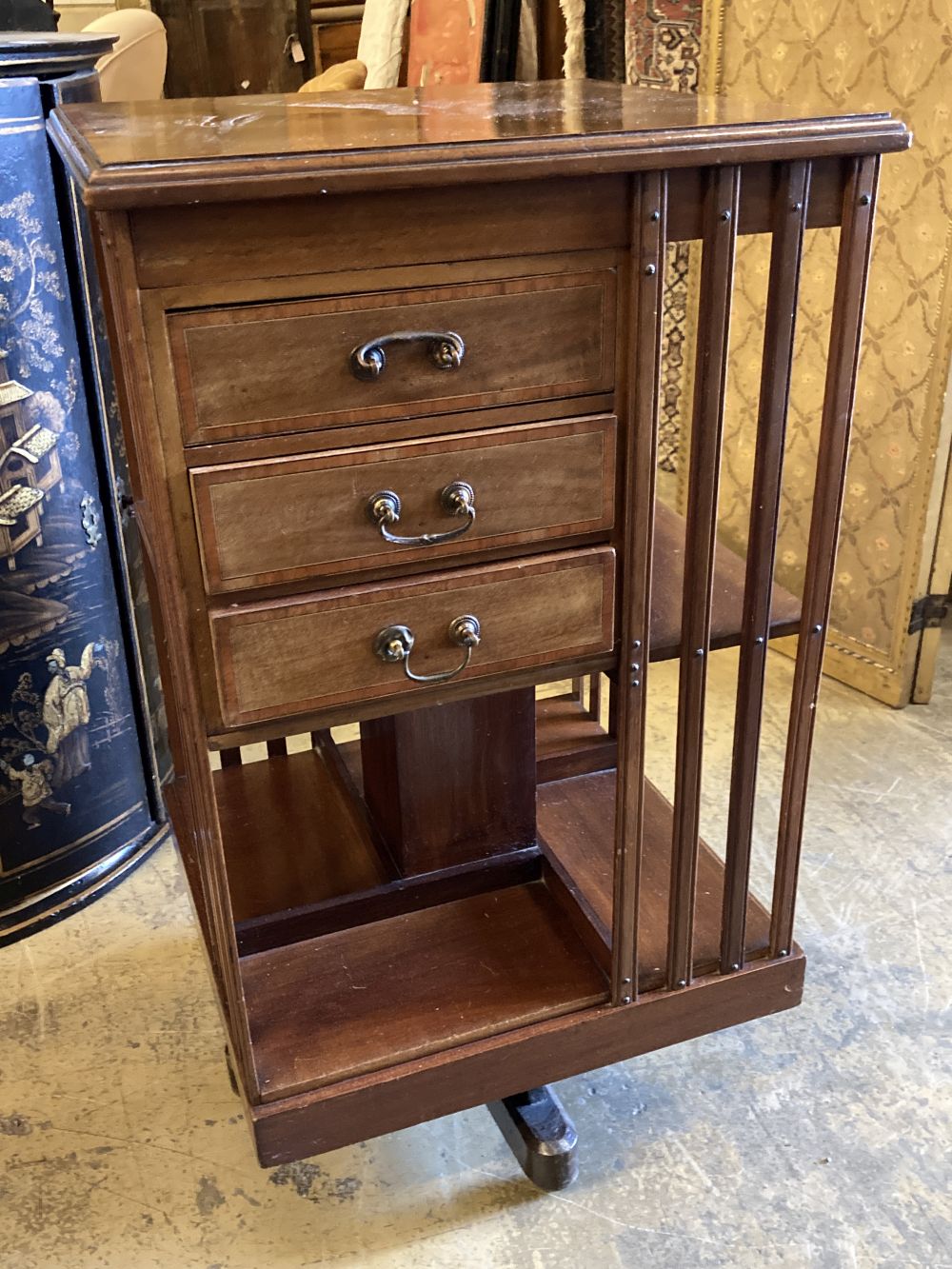 An Edwardian satinwood banded mahogany revolving bookcase, fitted drawers, width 48cm, depth 48cm, height 88cm